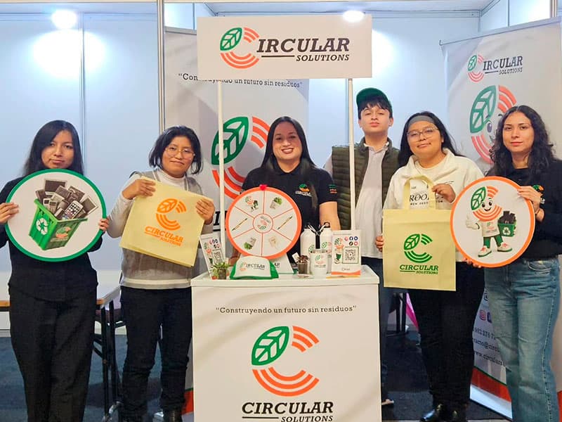 Circular Solutions team at a booth with recycling materials